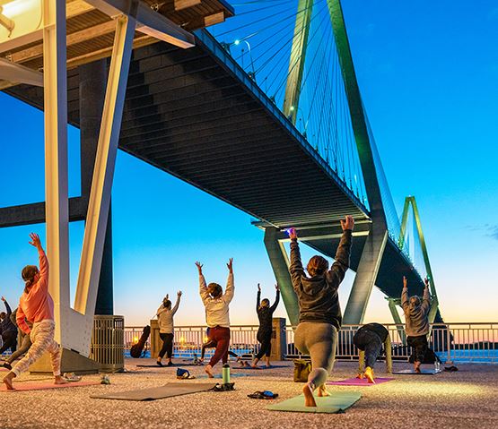 People doing yoga in the evening at the Mount Pleasant Pier