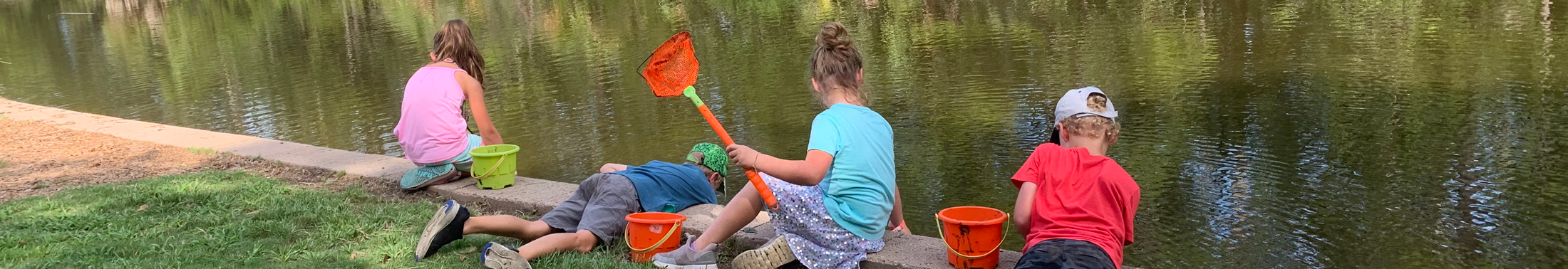 4 children in the park during a camp nature program