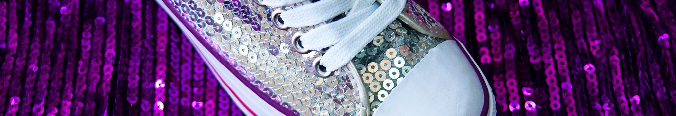 sneaker covered in silver sequins on a purple sequined background
