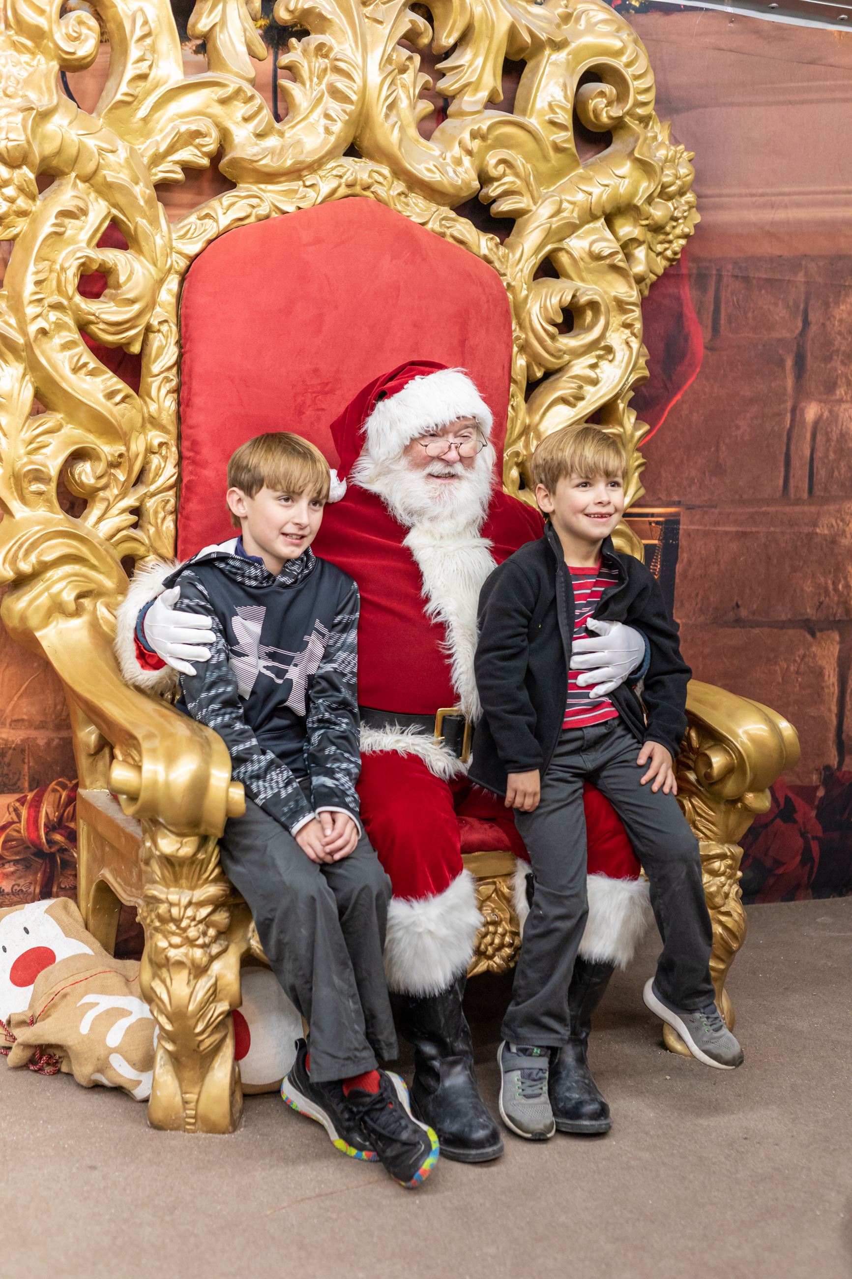 Santa Claus and two children smiling at camera